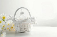 A gift white basket of empty baby bottle and folding baby napking recreation container fragility.