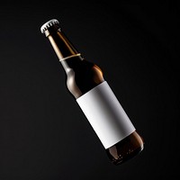 Beer bottle with white label drink black background refreshment.
