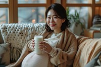 Pregnant korean woman drink drinking blanket.