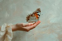 Oil painting of on pale hand holding a butterfly animal insect finger.