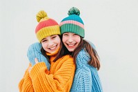 2 sisters wear beanie sweater smile laughing.