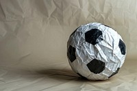 Football in style of crumpled paper sphere sports.