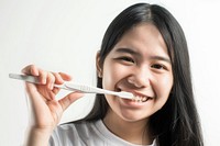 Teenage woman brush teeth smile toothbrush portrait.