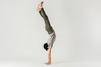 Teenage man handstand sports yoga white background.