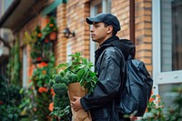 Delivery man delivering food plant architecture backpacking.