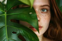 Girl with freckles posing adult plant green.