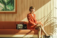 Businesswoman sitting in hotel lobby with suitcase adult sofa accessories.