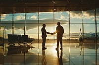 Businessmen making handshake with partner at airport aircraft airplane vehicle.