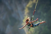 Woman in bungee jumping recreation adventure outdoors.