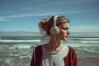 Woman Listens To Music beach headphones outdoors.