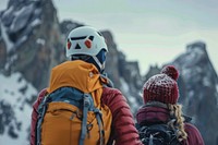 Climbing guide leads two clients backpacking clothing apparel.