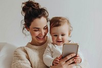 Woman using smartphone with toddler happy woman electronics.