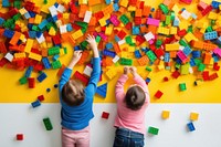 Children play with colorful plastic toy blocks person female human.