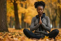 African american woman autumn yoga exercise.