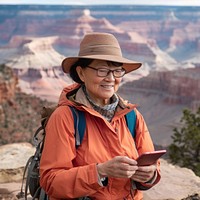 Women asian Tablet computer woman hiking grand canyon outdoors clothing.