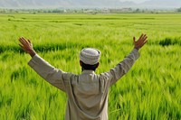 Middle eastern man field countryside triumphant.