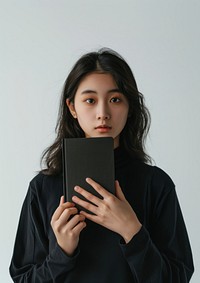 Holding a sleek black mini notebook photo photography electronics.