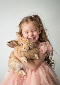 Hugging her fluffy brown rabbit photo dress girl.