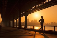 Man running silhouette photography jogging sunset bridge.