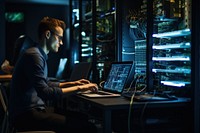 IT worker working on a laptop server electronics accessories.