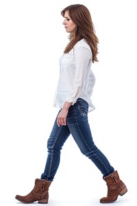 Full body shot of a woman walking jeans clothing footwear.