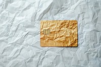 Credit card in style of crumpled paper aluminium text.