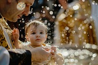 Priest is baptizing little baby girl in a church photo photography accessories.