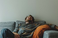 Tired man sleeping on sofa while dreaming about future person human adult.