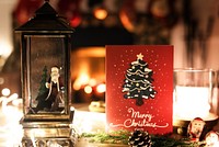 Cozy Christmas scene with a Christmas card, Christmas tree, and Christmas lights. Festive atmosphere with a Christmas card and Christmas decorations.