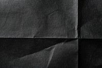 Black folded paper texture background clothing wrinkled.