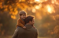 Father carrying a cute little boy background people person.