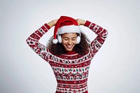 Joyful woman sweater headphones christmas.