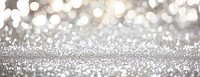 Shimmering bokeh background sparkling blurred silver.