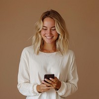 Woman looking on mobile phone blonde person happy.