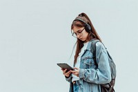 Woman looking on tablet headphones backpack student.