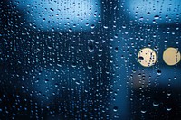 Rainy window with raindrops droplets atmosphere glass.