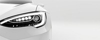 Close-up of the headlight and front light on a white car automobile background vehicle.