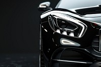 Close-up of the headlight and front light on a black car vehicle elegant transportation.