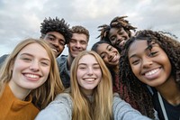 Group of diverse young adults selfie happy faces.