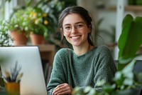 Smile female employee sweater glasses laptop.