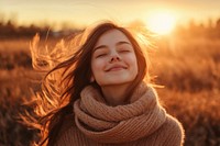 Happy woman outdoors sweater smiling.