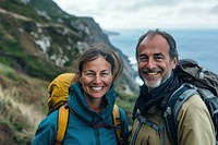 Middle-aged couple hiking backpacking adventure outdoors.