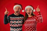 Young couple wearing Christmas sweaters background christmas santa.