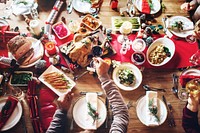 Top view of festive holiday dinner table with dishes, including turkey, vegetables, and desserts. A joyful Christmas gathering with vibrant decorations and delicious food. Christmas dinner.