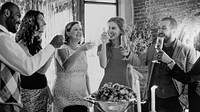 Group of people celebrating with drinks, smiling and toasting. Diverse group, mixed gender, enjoying a festive gathering with drinks and laughter. Celebration, gathering, festive season. 