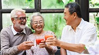 Group of diverse seniors enjoying a meal together, laughing and sharing drinks. Elderly friends, diverse gathering, joyful meal, happy seniors. Group of happy senior people enjoying the meal.