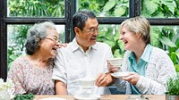 Three seniors enjoying tea and laughter. Diverse group of elderly friends sharing a joyful moment. Seniors, tea, and laughter in a cozy setting. Happy diverse senior friends enjpy tea time together