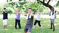 Group of diverse seniors exercise outdoors, healthy and energetic. Active diverse senior group enjoy fitness exercise in park. Healthy diverse seniors exercise in park, enjoy active outdoor fitness