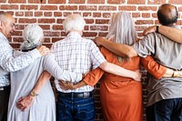 Diverse group of elderly people hugging, embracing each other. Elderly deivrse people showing unity and diversity. Elderly people hugging, diverse group, elderly people arms around each other