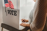 Woman voting in a booth privacy participation decision. Us election day voting booth, Voting booth with US flag. US election day. Vote for American democracy.